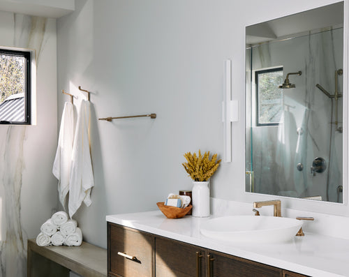 white bamboo bath towels rolled and hanging in elegant bathroom