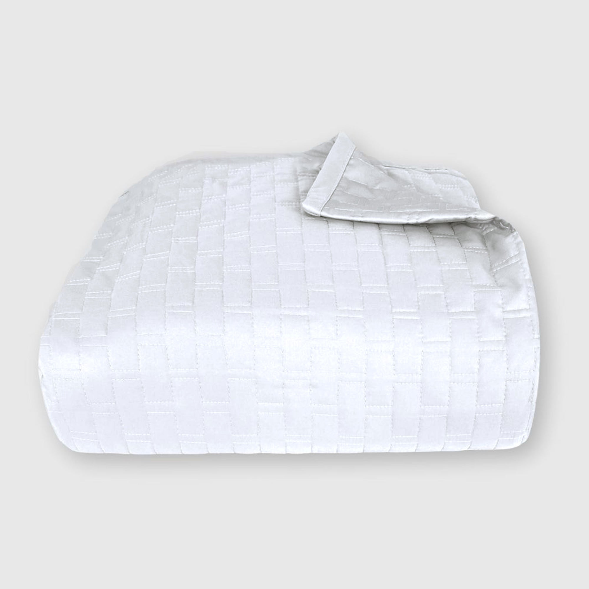 white bamboo quilted coverlet elegantly folded with brick pattern