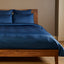 indigo blue silky bamboo duvet cover on a bamboo bed frame with standard sham pillows 