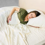 pregnant woman sleeping in ivory bamboo sheets 