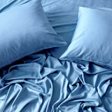 ocean blue  bamboo pillows laying on a messy bamboo sheet