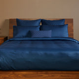 dark indigo blue bamboo duvet cover with pillows on an elegant bed 
