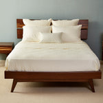 ivory quilted bamboo brick pattern coverlet on a pretty bamboo bed frame bedroom