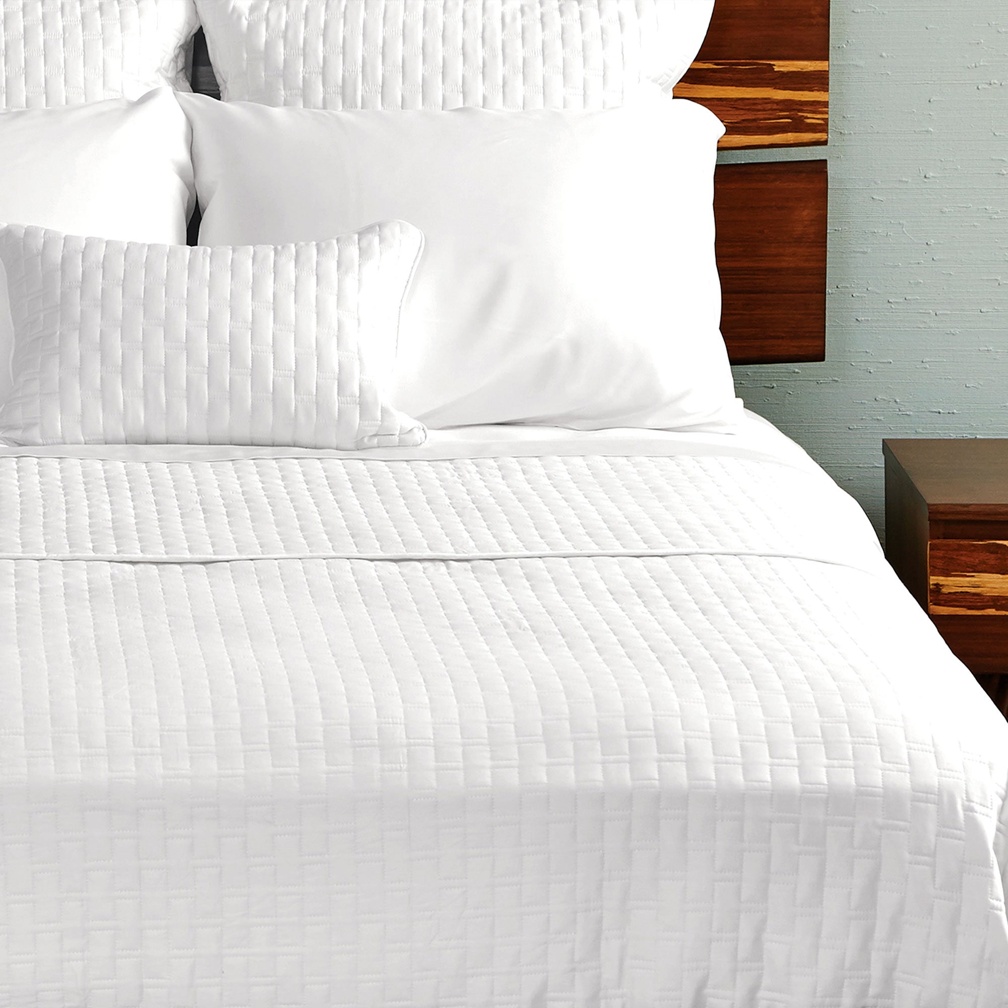 white bamboo quilted coverlet on a pretty bed with pillows