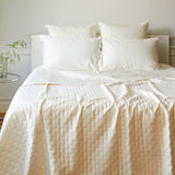 ivory bamboo quilted coverlet on a pretty bed in a bedroom