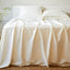 ivory bamboo sheet set and pillows on an elegant bed