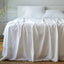 white bamboo sheet set and pillows on an elegant bed