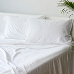 white bamboo pillowcase and sheet set with pillow on a bed