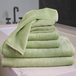 stack of 8 piece sage bamboo bath towel hand towel and washcloths on bathroom counter