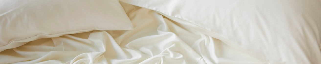 Close-up of beige bedding with a soft texture