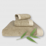 beige 3 piece bamboo towel stack with bamboo plant
