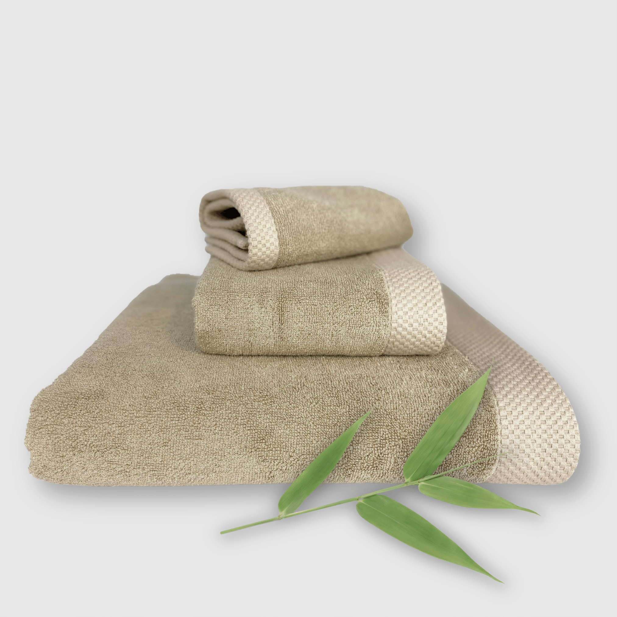 beige 3 piece bamboo towel stack with bamboo plant
