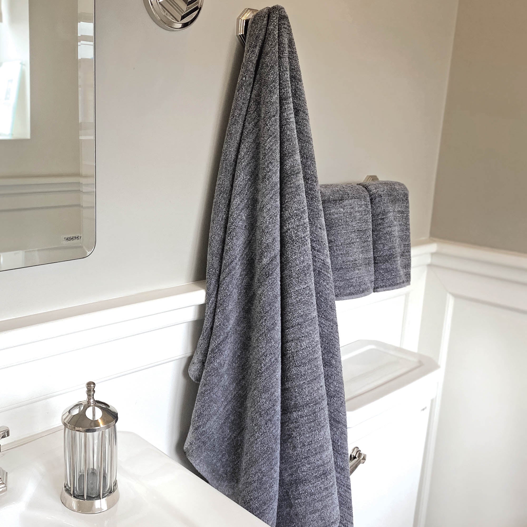 charcoal gray melange bamboo bath sheet and hand towels hanging in a bathroom
