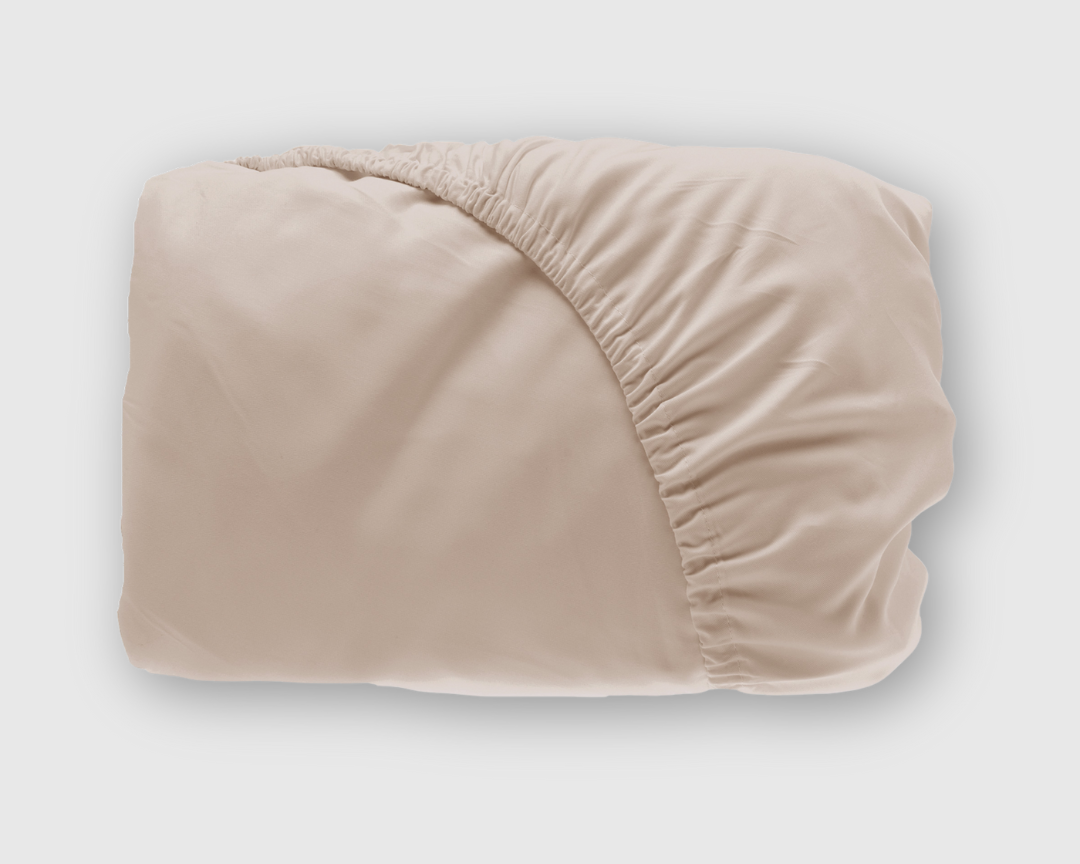 beige bamboo fitted sheet shown folded with elastic