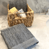 charcoal dark gray melange bamboo hand towel with woven basket on bathroom counter