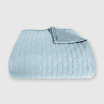 light blue sky bamboo quilted coverlet elegantly folded with brick pattern