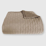 dark tan champagne beige bamboo quilted coverlet elegantly folded with brick pattern