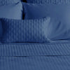 dark indigo blue bamboo coverlet and pillows on a bed