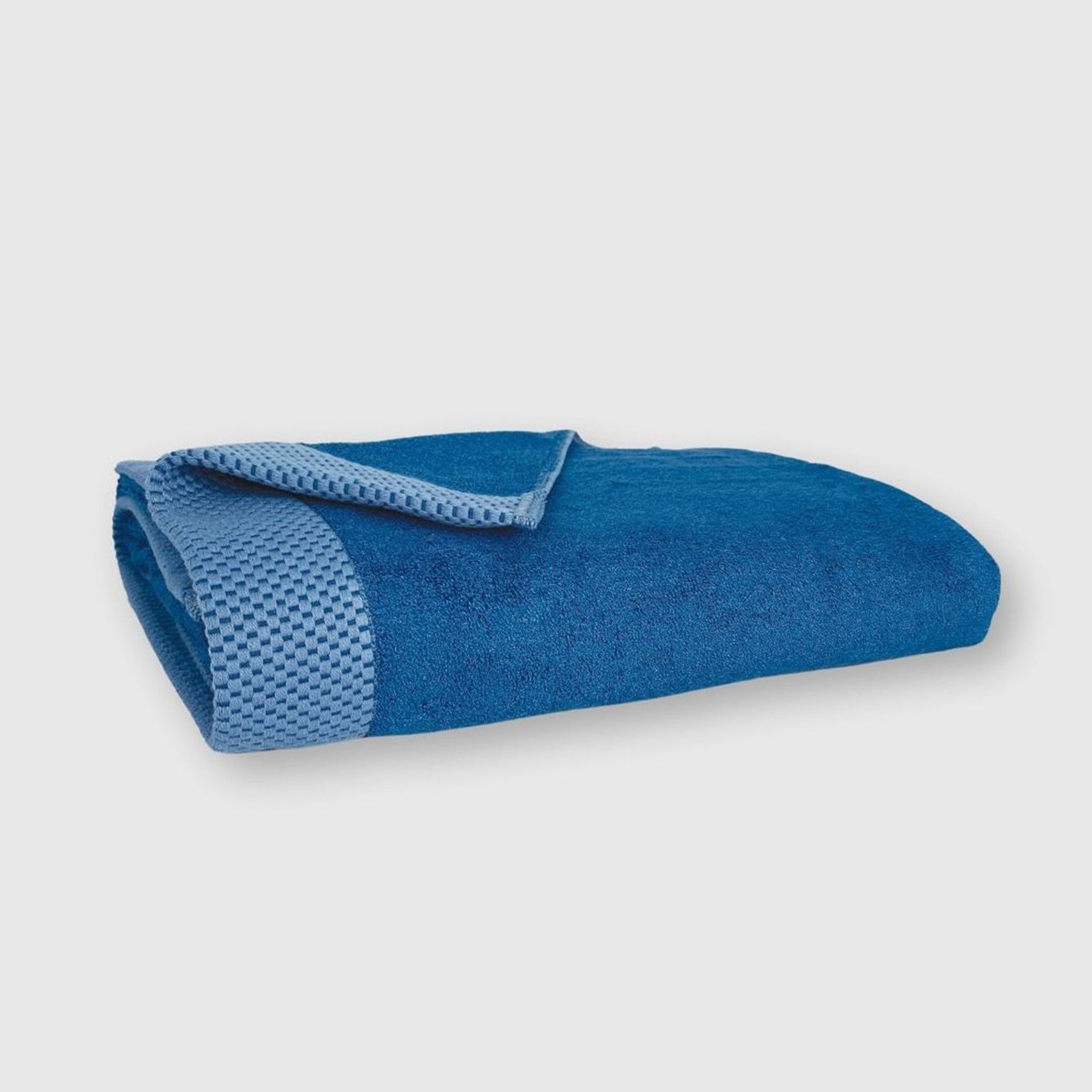 dark blue indigo bamboo bath towel folded with basket weave edge pattern