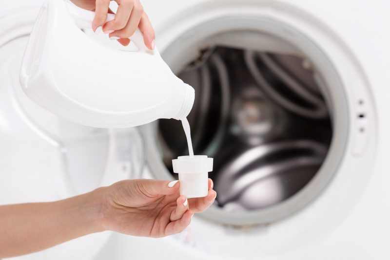 pouring laundry soap
