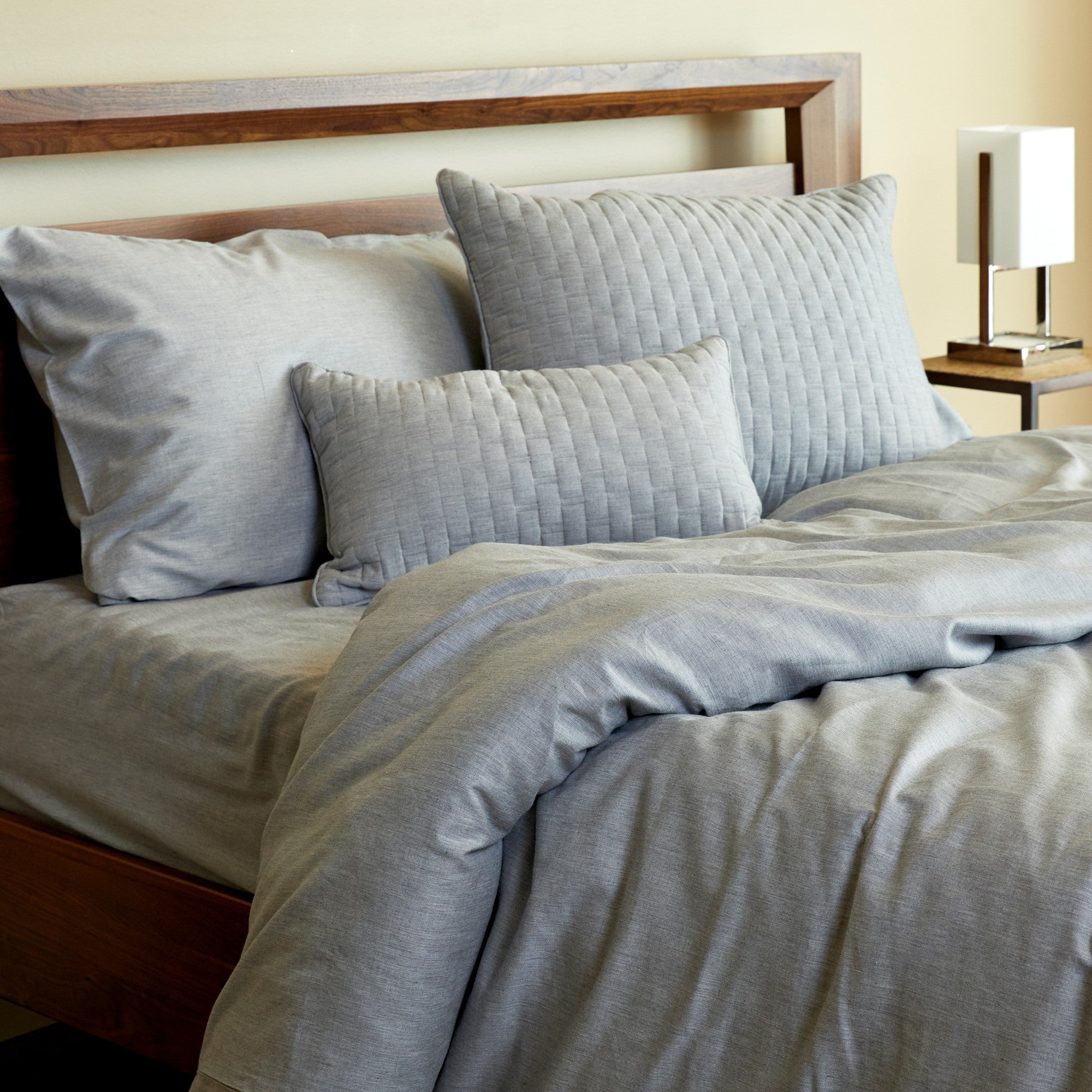 silver gray bamboo melange sheet set duvet cover and pillows in a fun and messy bed