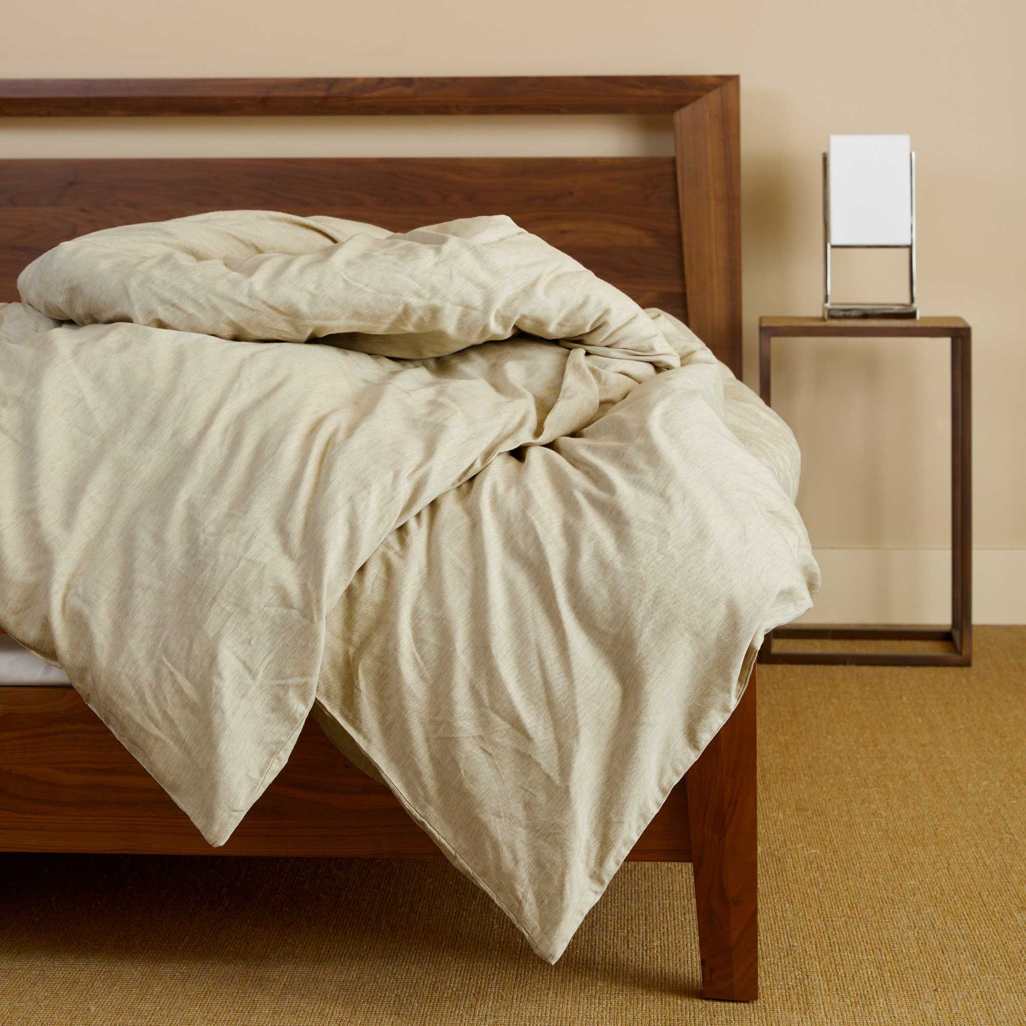 beige sand melange bamboo duvet cover draped over a pretty bed