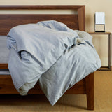 silver gray melange bamboo duvet cover draped over bed