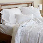snow white melange bamboo duvet cover and sheet set with pillows on made bed