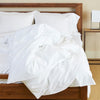 snow white bamboo melange duvet cover draped over bed