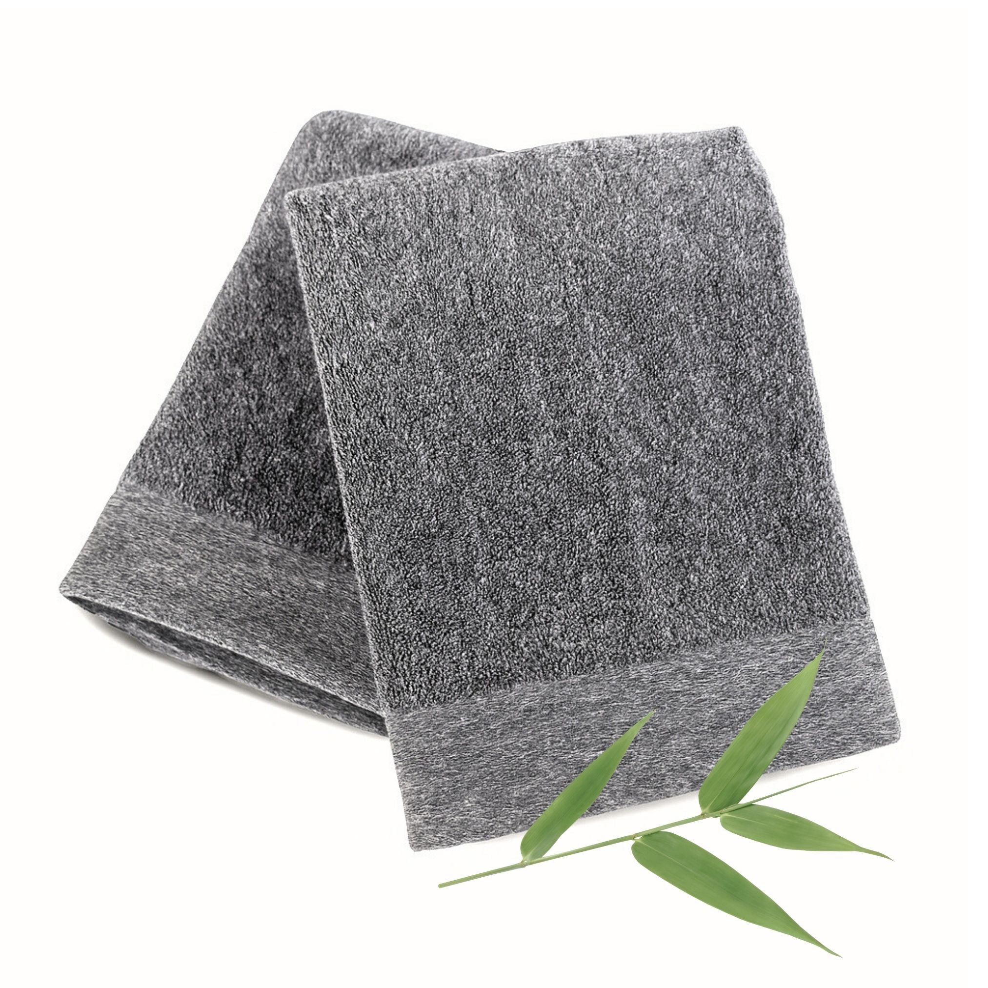 Gray towel with a green leaf on a white background
