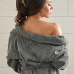 woman wearing a charcoal bamboo bathrobe in tile shower