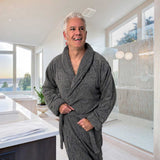 dark gray charcoal bathrobe on man standing in bathroom near shower