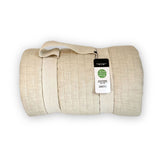 beige sand melange bamboo quilted coverlet rolled up and shown in packaging