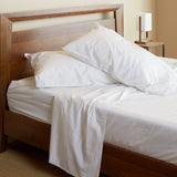 snow white melange bamboo bed sheet set with pillows on a bedframe