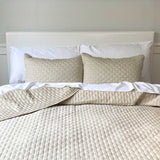 bed image with sand beige bamboo melange quilted coverlet and standard shams with brick pattern