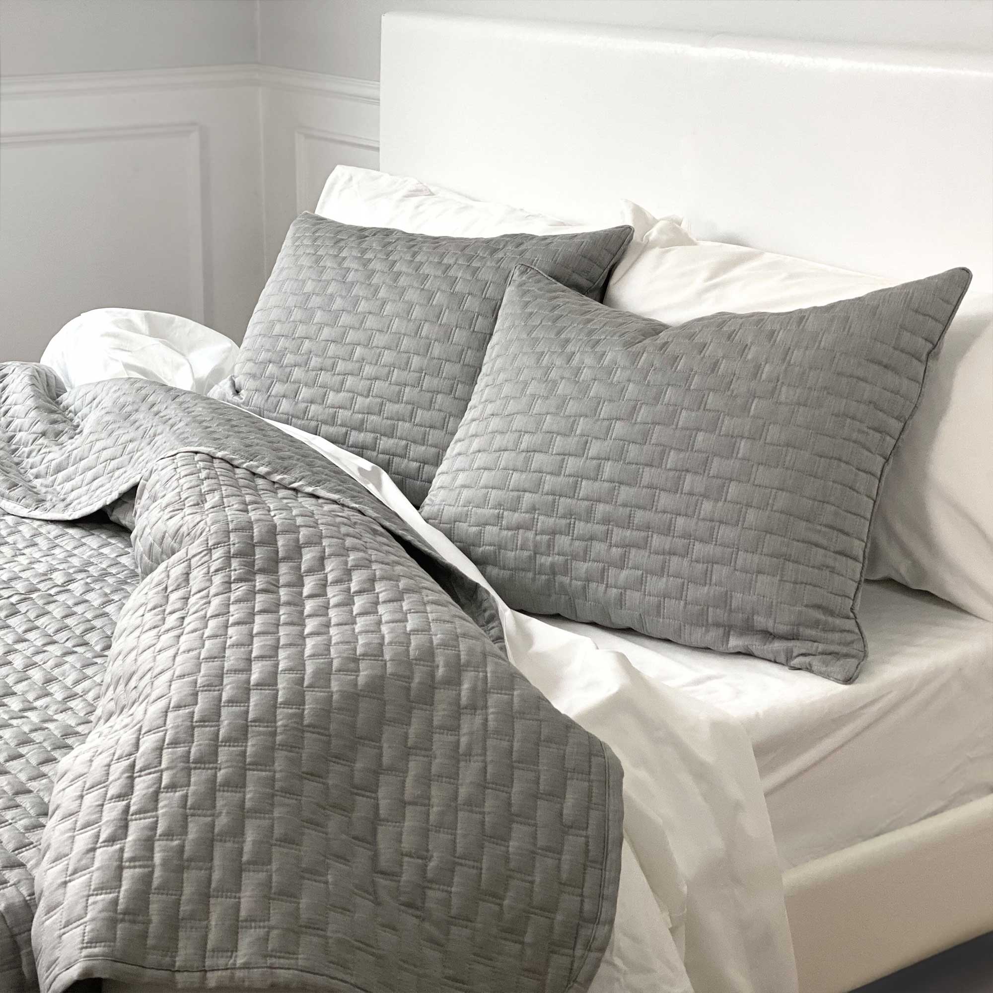 cozy bed with silver gray quilted melange bamboo coverlet and standard shams