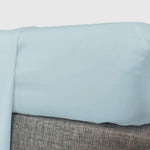 light blue sky bamboo fitted sheet shown on corner of mattress