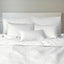 white snow bamboo melange quilted coverlet and decorative pillows on a bed