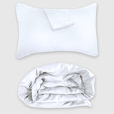 white bamboo duvet cover rolled up with cozy pillow shams floating above it