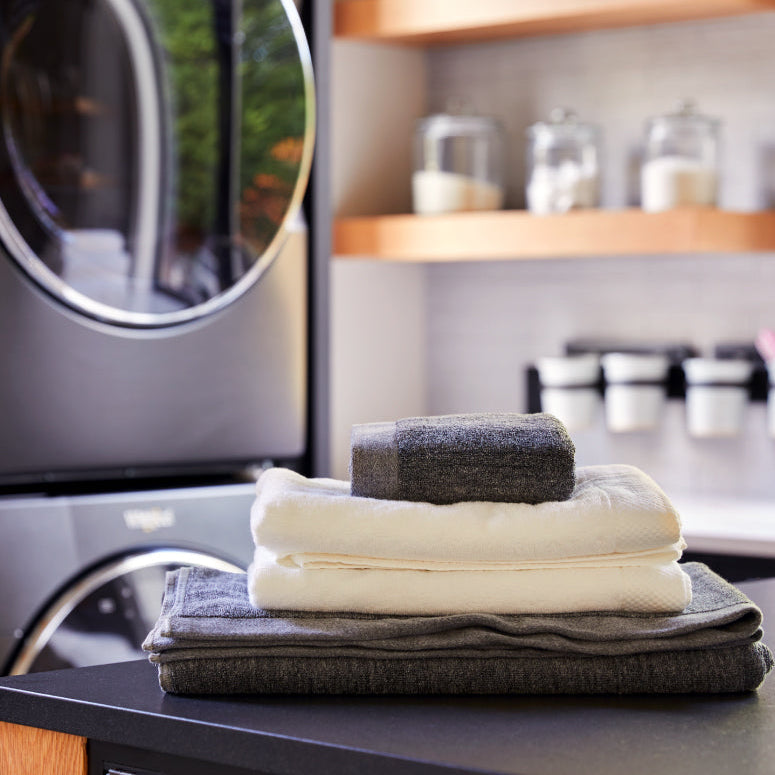 Stack of towels of different sizes in laundry room