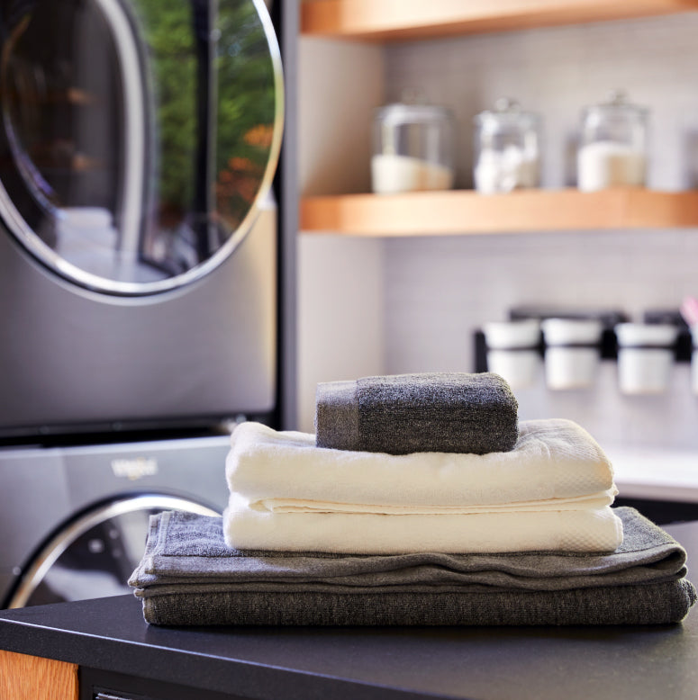 Stack of towels of different sizes in laundry room
