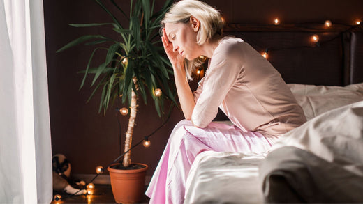 Woman sitting upright in bed during hot flash