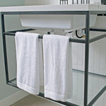 white bamboo hand towel set hanging from bar on bathroom sink