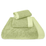 Set of green towels with textured border on a white background