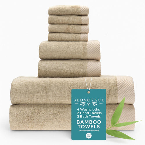 Stack of beige towels with a Bedvoyage tag on a white background