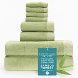 Stack of green bamboo towels with a 'Bed Voyage' tag on a white background
