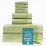 Stack of green bamboo towels with a 'Bed Voyage' tag on a white background
