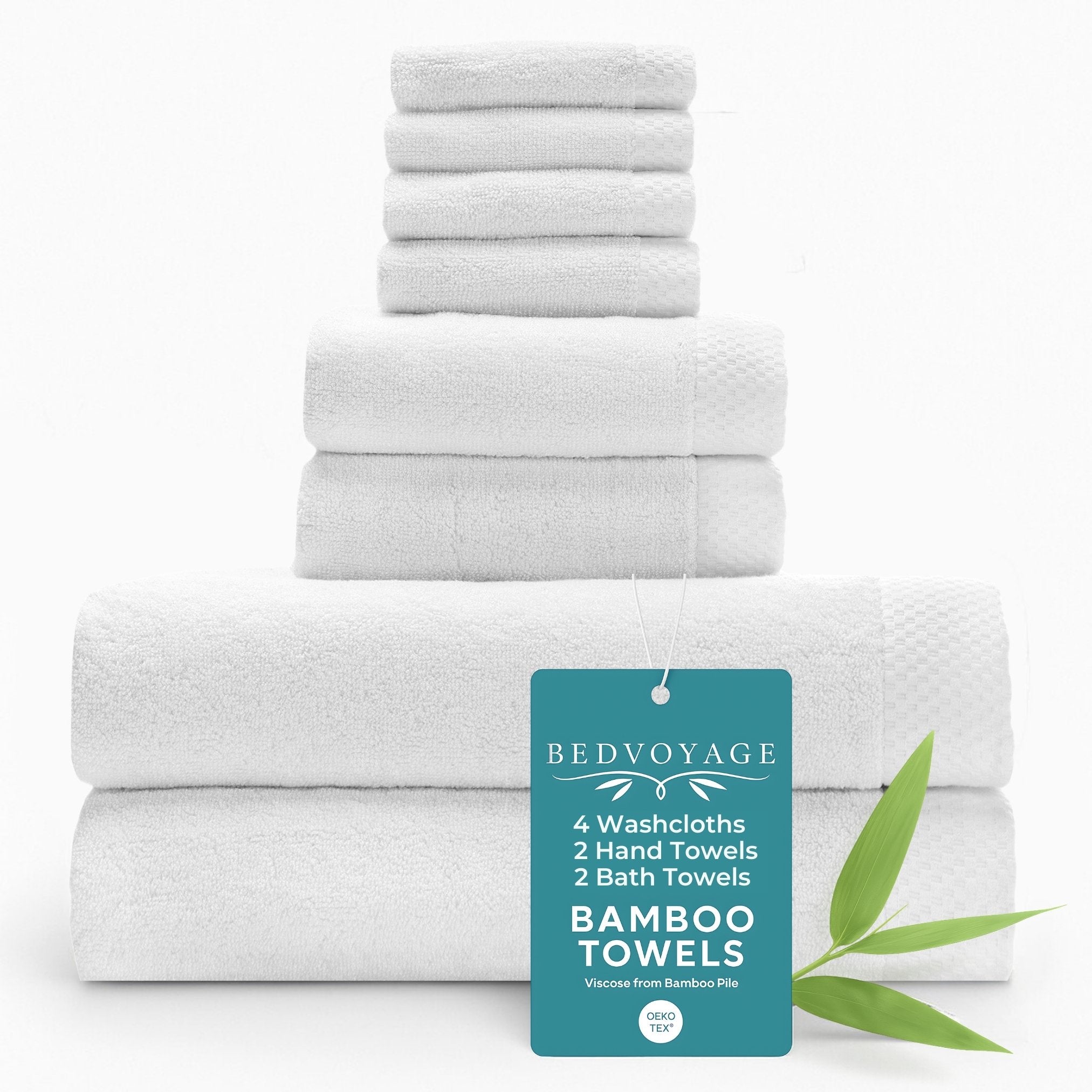 Set of white bamboo towels with a 'Bed Voyage' tag on a white background