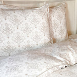 white and tan damask pattern on bamboo duvet cover and matching shams on bed