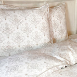 white and tan damask pattern on bamboo duvet cover and matching shams on bed